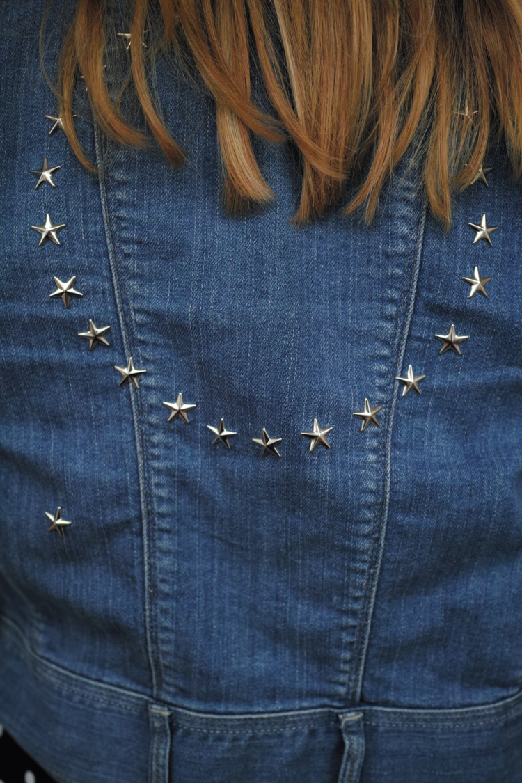 The back of a jacket ornamented with silver stars.